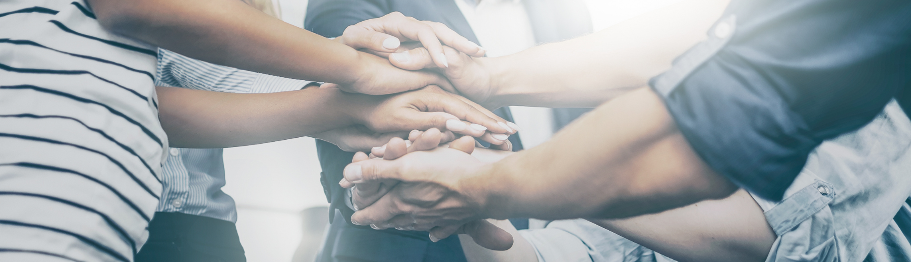 A diverse group of hands stacked on one another